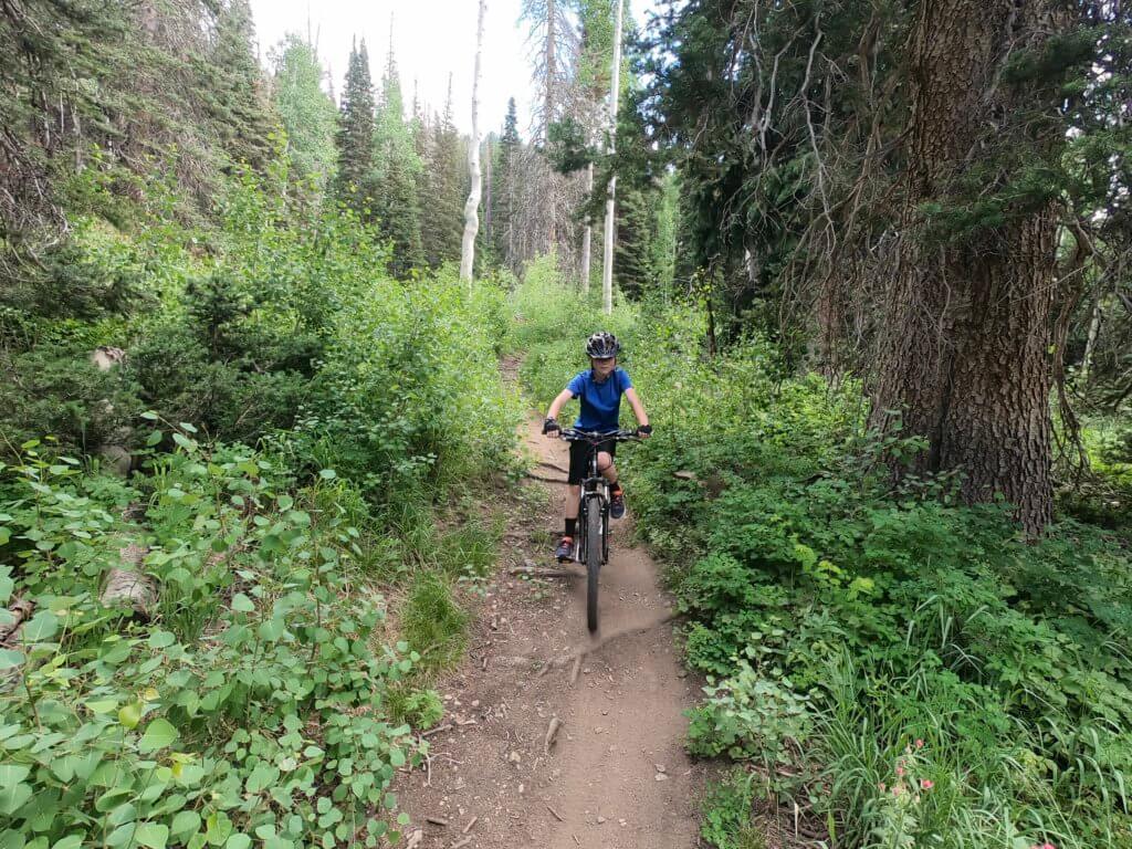 Boy mountain biking on dirt trails at Solitude