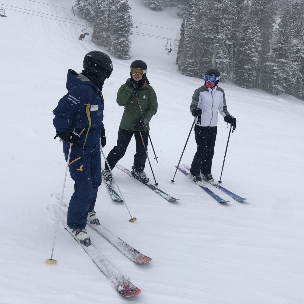 Women take instruction from Ski & Ride School ski instructor, Kelly
