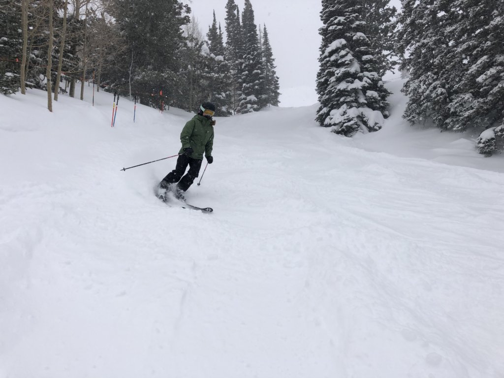 Bailey skiing in powder on Women on Wednesdays