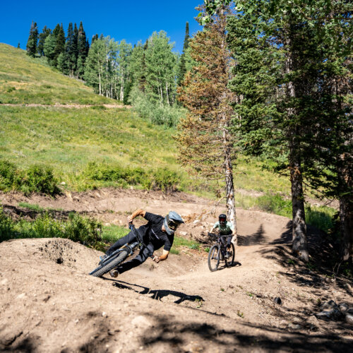 Two bikers riding the berms at Solitude Bike Park