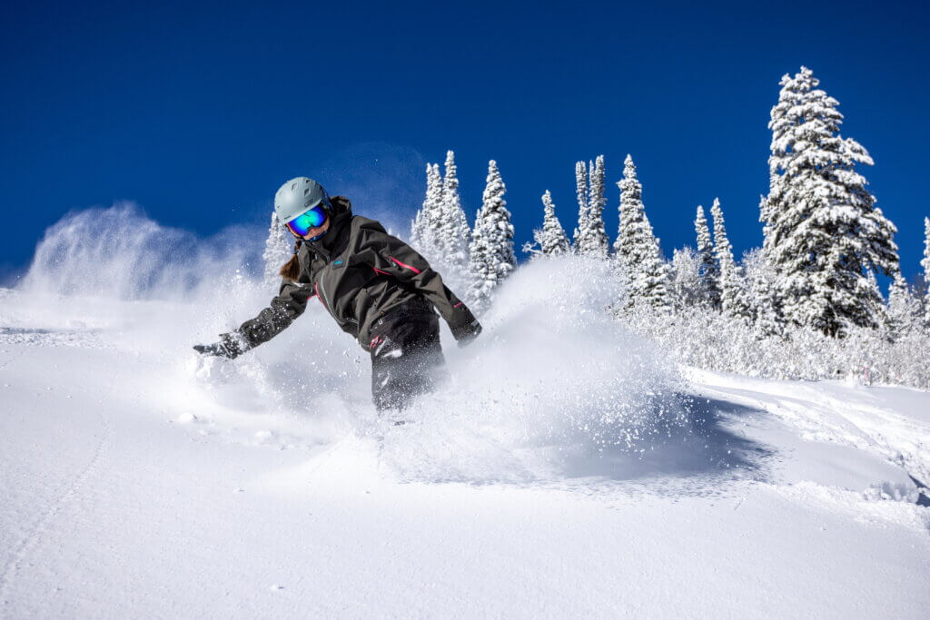 Snowboarder in deep powder at solitude