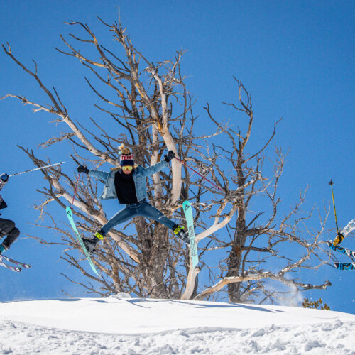 skiers and snowboarders at solitude during the spring, jumping