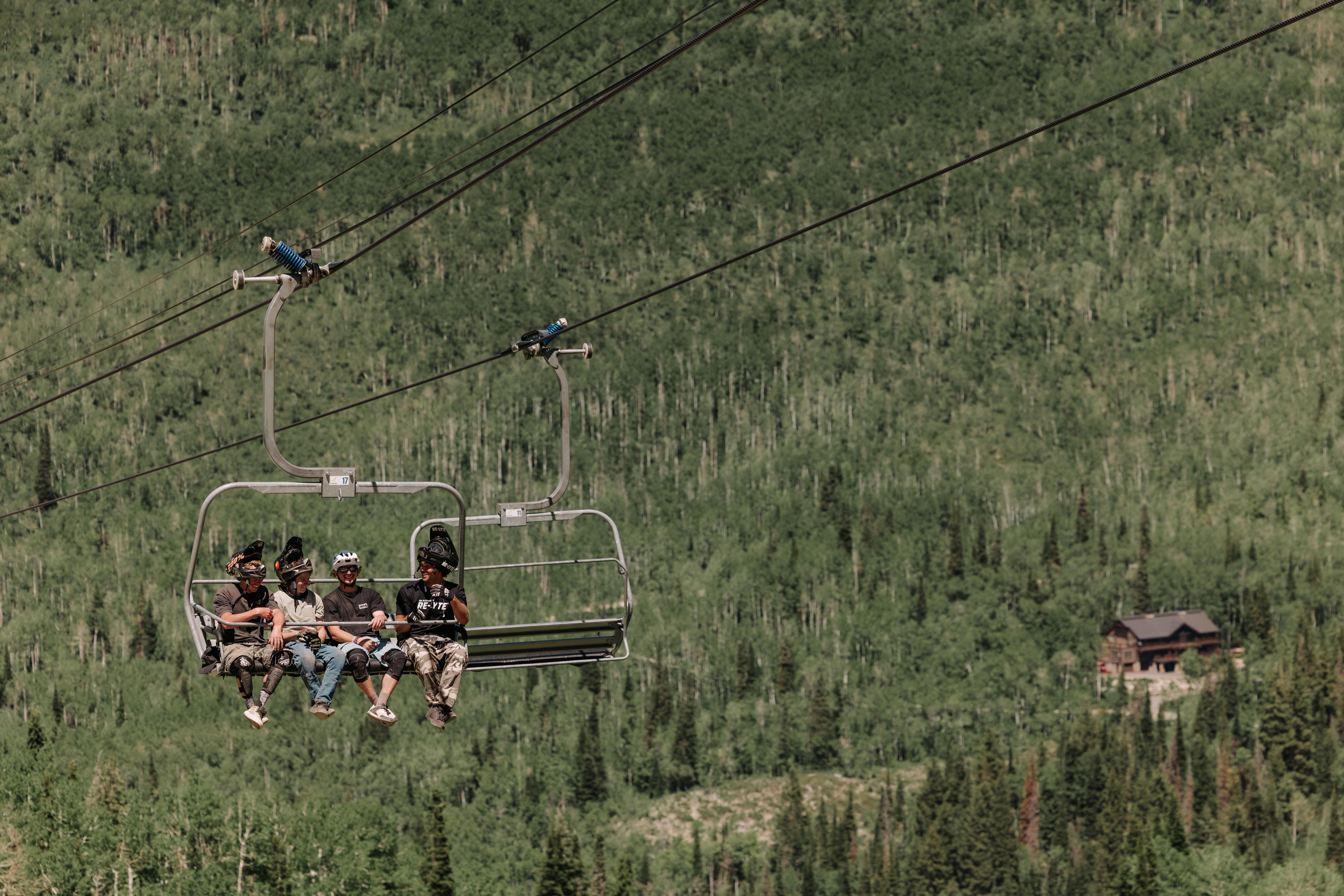 Friends ride moonbeam lift while biking at Solitude Bike Park